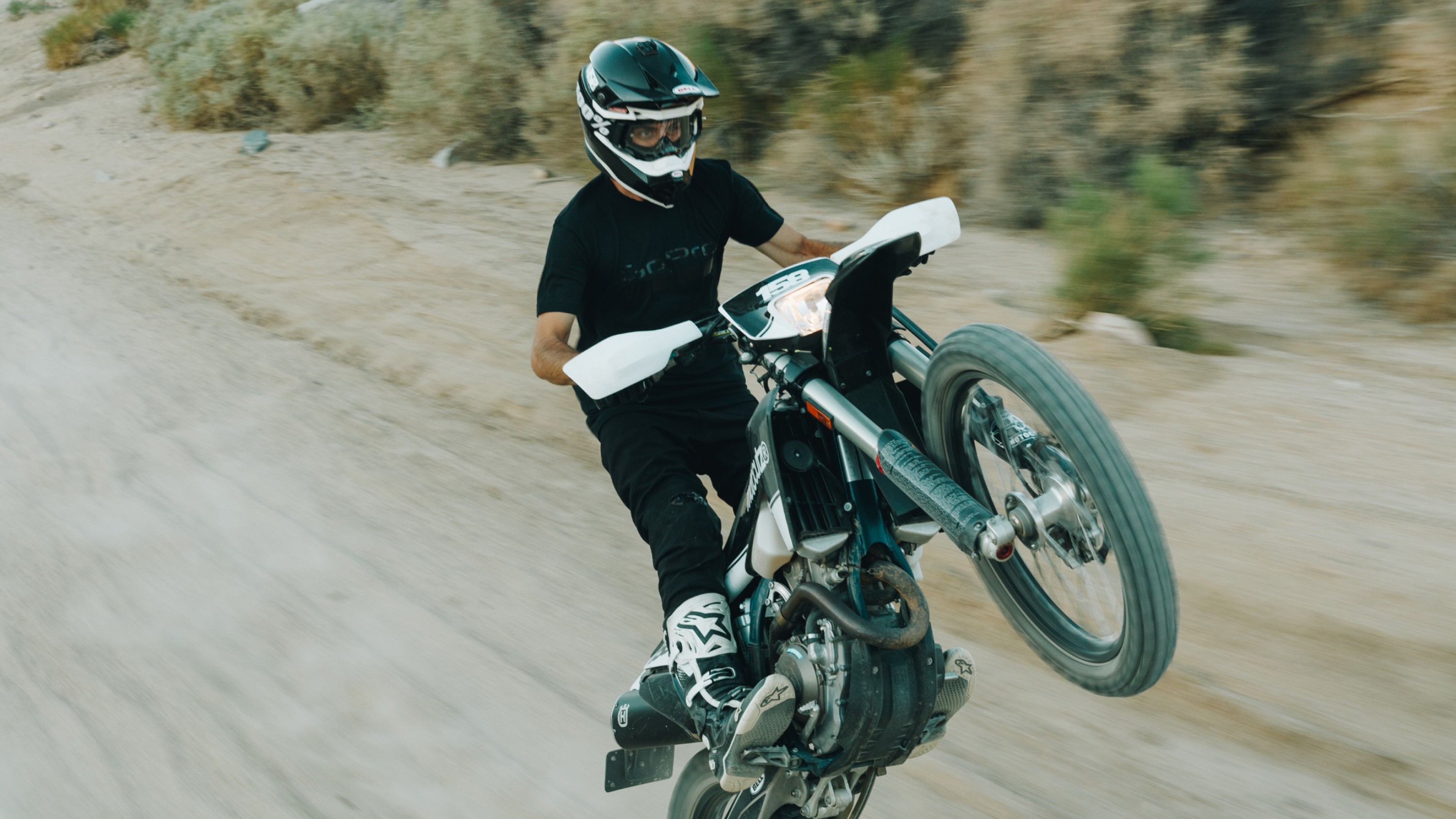 man wearing GoPro After Party - Logo Graphic Tee on a motorbike