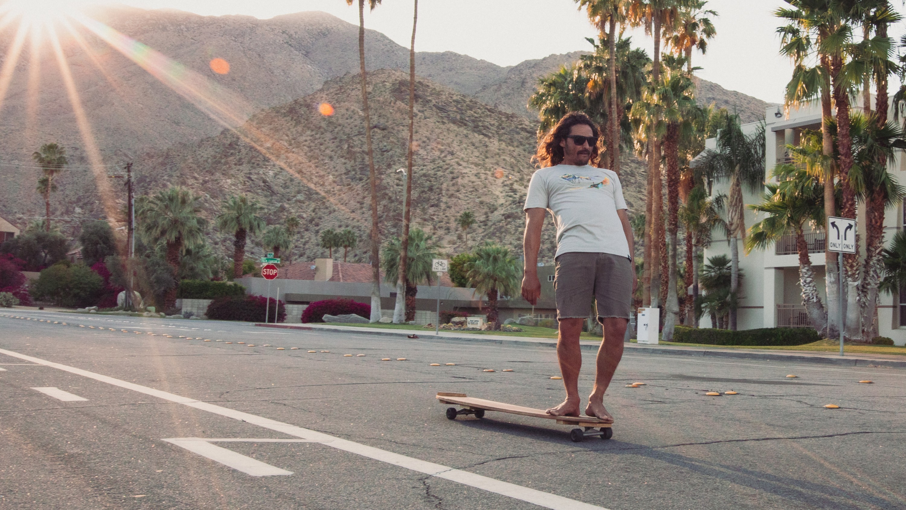 Longboarder wearing GoPro Elevation Graphic Tee (Men’s T-Shirt)